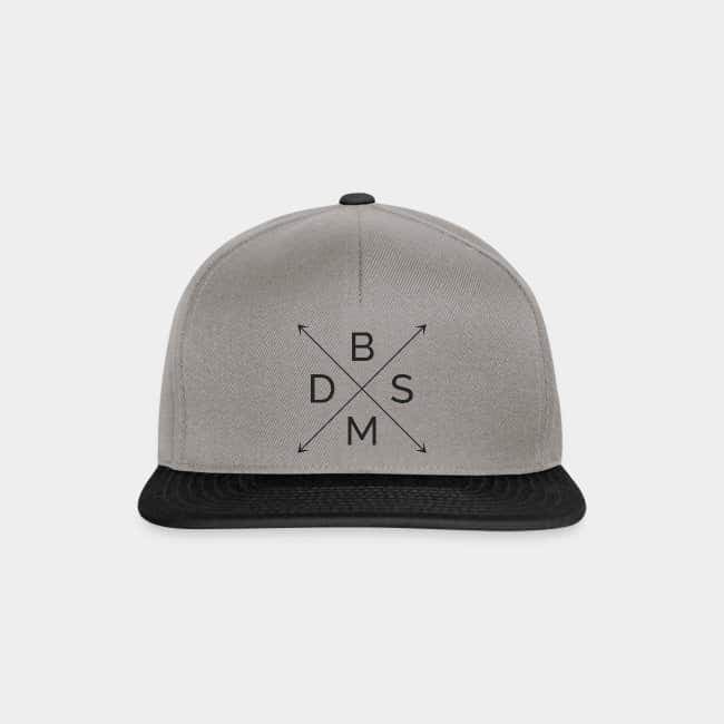 Grey snapback cap with a black brim and the letters B, D, S and M in an arrow cross