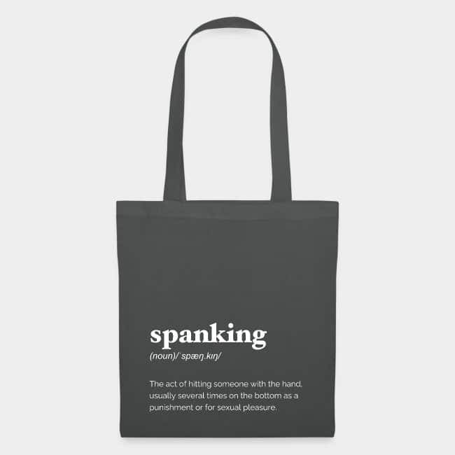 Dark grey tote bag printed with the dictionary definition of “spanking” in white