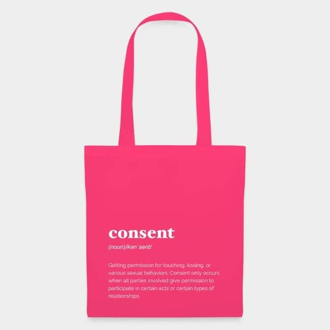 Pink tote bag printed with the dictionary definition of “consent” in white