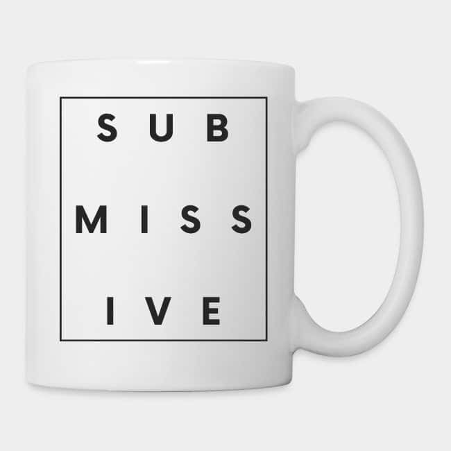 White mug with the word “SUBMISSIVE” inside a black frame